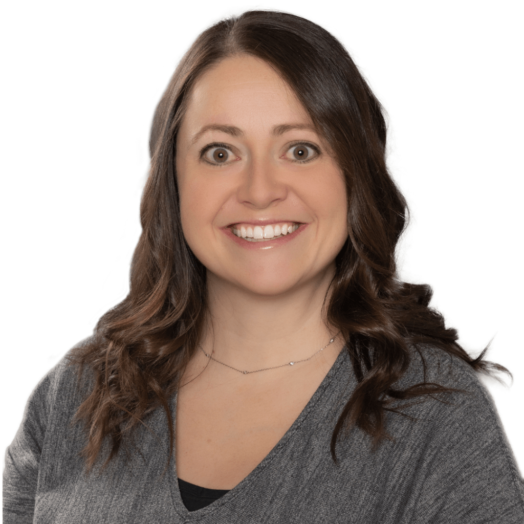 Professional headshot of a smiling real estate advisor in a gray sweater, showcasing friendly and approachable expertise in Montana real estate services.